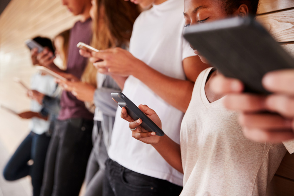 Group of young people find out that you can unlock a Straight Talk mobile phone online.