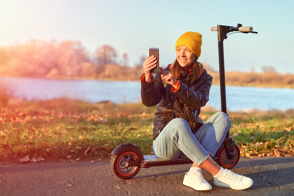 Young woman sat on her scooter after unlocking her Sprint phone without an account.