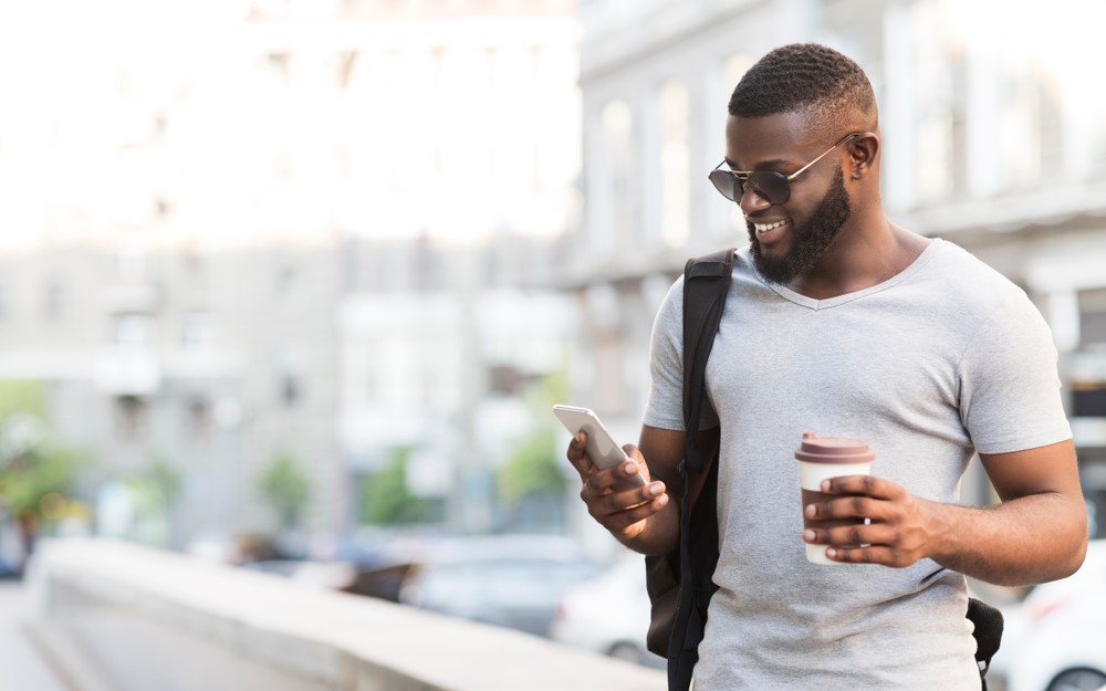 African American man finding out how to unlock a verizon phone to use on another network.