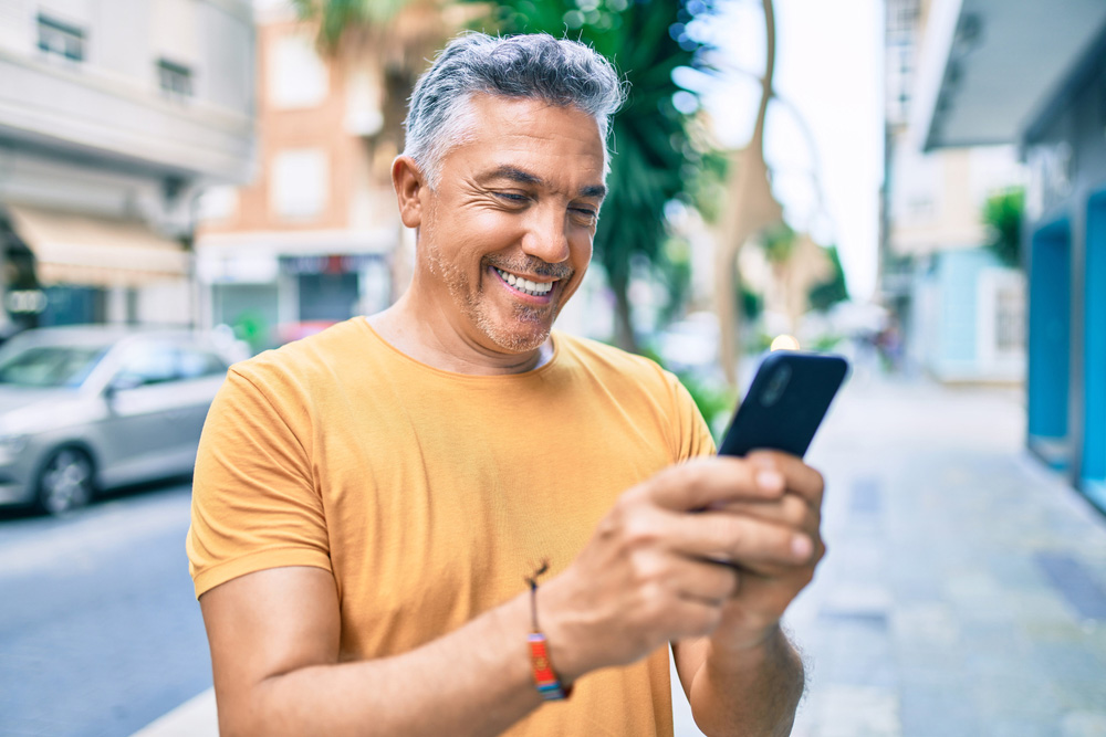 Smiling middle aged man after unlocking an o2 phone online with Mobile Unlocked.