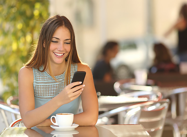 Young woman sat down to unlock her T-Mobile Iphone online.